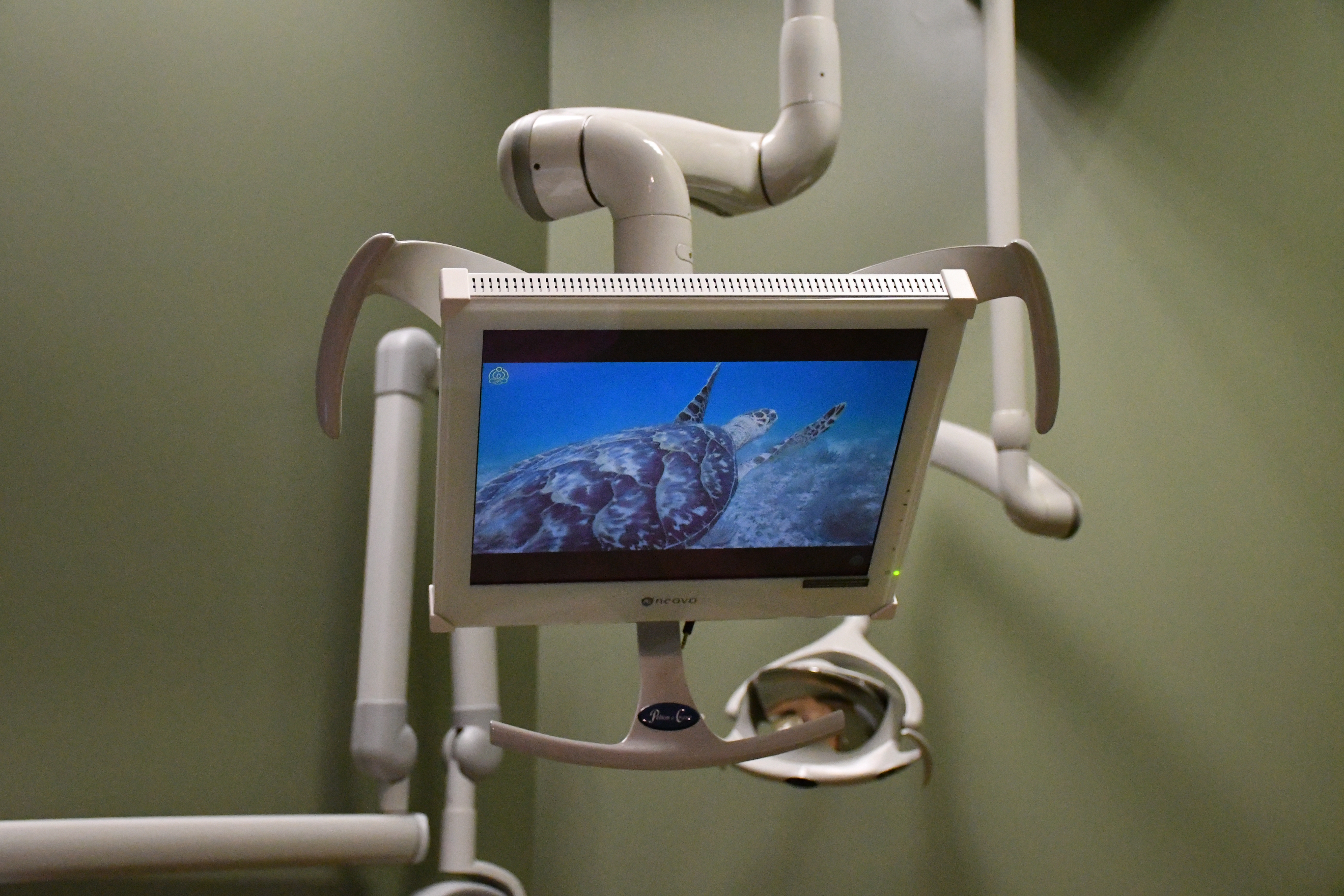 Swing arm monitors mounted in the dental operatory for patient entertainment